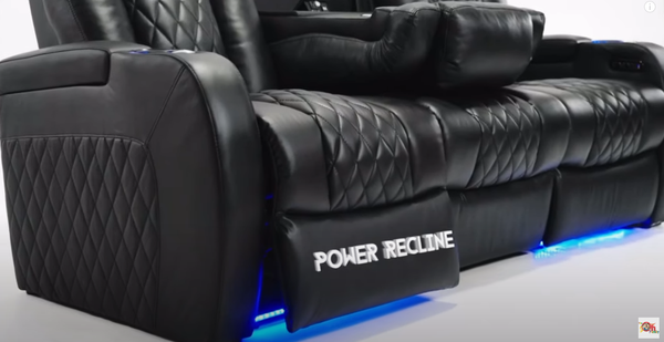 Side view of a leather power recliner chair in a fully reclined position, with blue LED lighting underneath